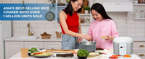 Two people cooking with an advertised rice cooker in a kitchen, surrounded by ingredients.