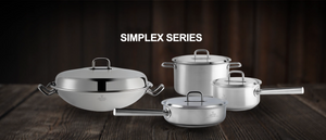 A set of four shiny stainless steel pots and pans from Simplex Series on a wooden table.