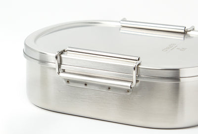 Stainless steel lunchbox with a latched lid, isolated on a white background.